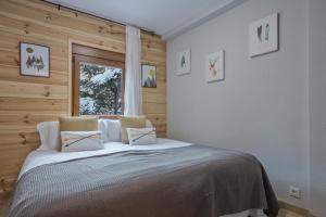 a bedroom with a large bed with a window at Apartamento Renovado Baqueira 1500 in Naut Aran