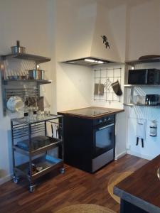 a kitchen with a black stove and a counter at Gårdshuset in Söderhamn