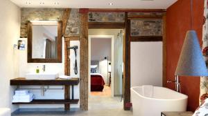 a bathroom with a tub and a sink and a mirror at Romantik Hotel Markusturm in Rothenburg ob der Tauber