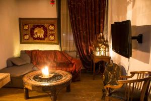 a living room with a candle on a coffee table at Dharma Luxury & Spa Apartment in Serres