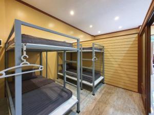 a room with three bunk beds in a room at We Hostel Khaolak in Khao Lak