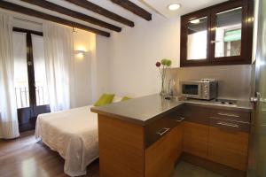 Una cocina con microondas y una cama en una habitación. en BCN2STAY Apartments, en Barcelona