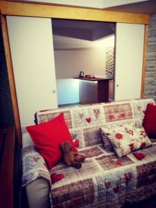 a teddy bear sitting on a couch in a room at Noemi Marilleva vacanze in Marilleva