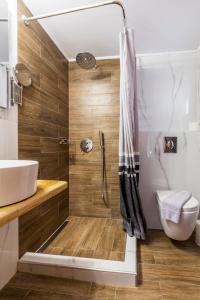 a bathroom with a shower and a sink at Hotel Almira in Agia Triada
