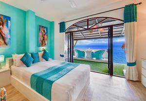 a bedroom with a bed with a view of the ocean at Hacienda Fisherman's Village Koh Samui in Bophut