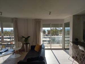 a living room with a couch and a table at Luxury Apartment Accommodation, next to beach & train station Calella in Calella