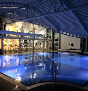 a large swimming pool in a large building at Silverdale Lodge Hot Tub & Wifi in Warton
