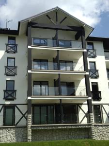 an apartment building with balconies on it at PIAM Apartamenty in Świeradów-Zdrój