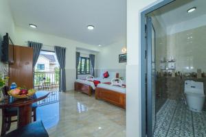 Postel nebo postele na pokoji v ubytování Coco Village Homestay Hoi An
