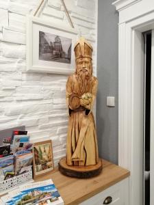 a statue of a man sitting on top of a table at Apartman Sv. Urban in Bratislava