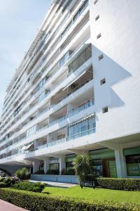 a large white building with an arrow on it at Peninsula in Punta del Este