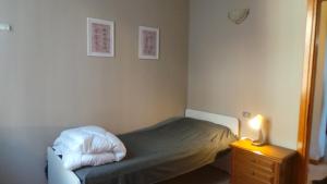 a small bedroom with a bed and a night stand at da Irma in terrazza in Crema