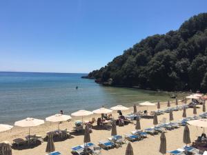 a group of umbrellas and chairs on a beach at Grand Hotel Il Ninfeo in Gaeta