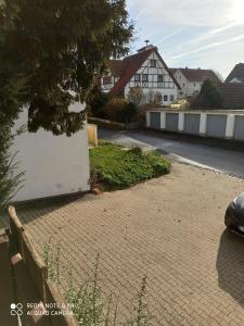 a brick driveway with a white wall and a house at Günther´s Ferienwohnung in Pegnitz