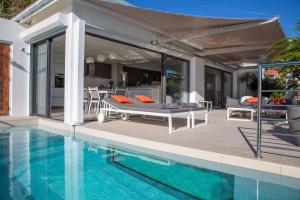 a villa with a swimming pool and a patio at Villa AKA walking acces to beach in Saint Barthelemy