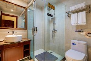 a bathroom with a shower and a toilet and a sink at Floral Hotel · Shangri-la Blue Sky in Shangri-La