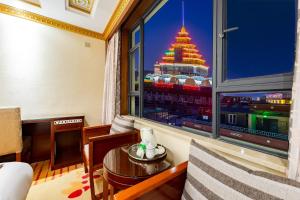 a room with a view of a building from a window at Floral Hotel · Shangri-la Blue Sky in Shangri-La