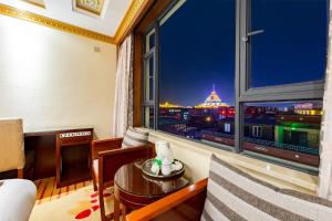 a room with a large window with a city view at Floral Hotel · Shangri-la Blue Sky in Shangri-La