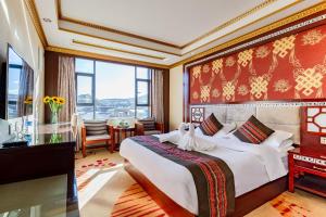 a bedroom with a large bed and a large window at Floral Hotel · Shangri-la Blue Sky in Shangri-La