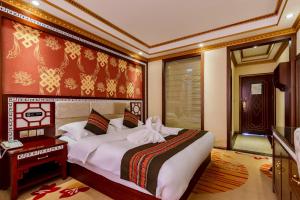 a bedroom with a large bed in a room at Floral Hotel · Shangri-la Blue Sky in Shangri-La