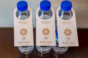 a group of three bottles of water with blue caps at Floral Hotel · Shangri-la Blue Sky in Shangri-La
