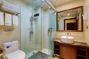 a bathroom with a shower and a toilet and a sink at Floral Hotel · Shangri-la Blue Sky in Shangri-La