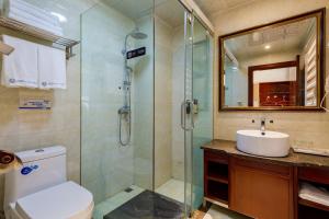 a bathroom with a shower and a toilet and a sink at Floral Hotel · Shangri-la Blue Sky in Shangri-La