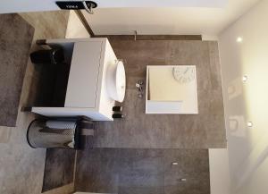a bathroom with a sink and a paper towel dispenser at FeWo Püttlingen in Püttlingen
