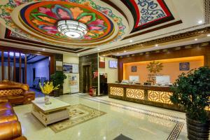 a lobby of a hotel with a reception desk at Floral Hotel · Shangri-la Blue Sky in Shangri-La