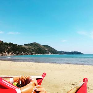 a couple of lawn chairs on a beach at Grand Hotel Il Ninfeo in Gaeta