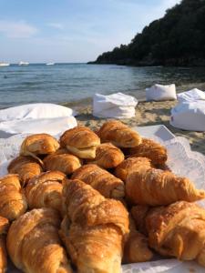 a pile of pastries sitting on a table near the water at Grand Hotel Il Ninfeo in Gaeta