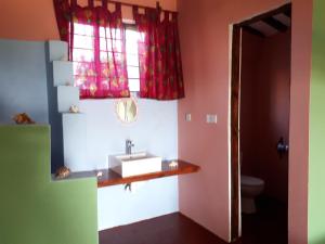 a bathroom with a sink and a window at Jua Peponi in Michamvi +107 photos