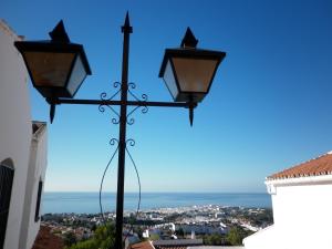 a street light with a view of the ocean at El Capistrano Sur in Nerja