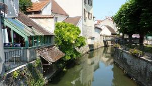 a river in the middle of a city with houses at Petit séjour en chalet in Crécy-la-Chapelle