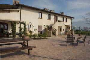 a house with chairs and a table in front of it at Agriturismo Il Barco in Spello