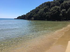 a boat in the water next to a beach at Grand Hotel Il Ninfeo in Gaeta