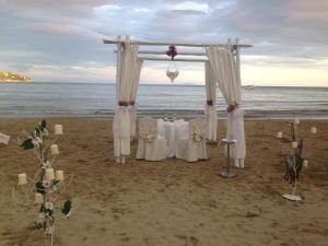 a wedding altar on a beach with the ocean at Grand Hotel Il Ninfeo in Gaeta