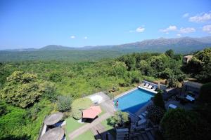 an overhead view of a swimming pool with mountains in the background at Appartement du Tourisme in Zonza