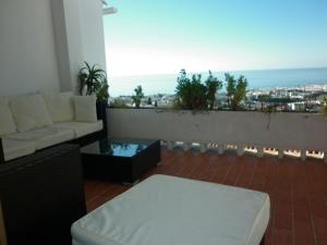 a living room with a couch and a view of the ocean at El Capistrano Sur in Nerja