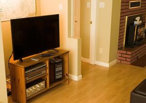 a flat screen tv sitting on a wooden entertainment center at Inlet Beach House B&B in North Saanich