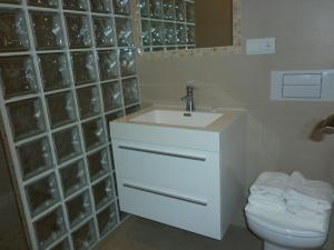 a white bathroom with a sink and a toilet at El Capistrano Sur in Nerja