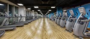 a row of rows of treadmills in a gym at Park Azure Deluxe Home 526 in Baku