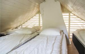 a couple of beds in a room with windows at Amazing Home In Gamleby in Gamleby