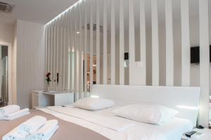 a bedroom with two beds with white pillows at B&B Schlosser in Zagreb