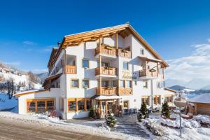 a hotel in the mountains with snow on the ground at Hotel Antermoia in Antermoia