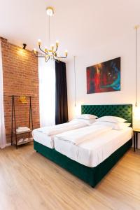 a bedroom with a large bed and a brick wall at SmartRoomsZagreb in Zagreb