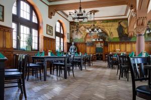 a dining room with tables and chairs in a building at Hotel Hoepfner Burghof in Karlsruhe