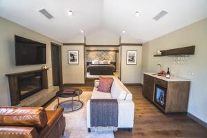 a living room with a couch and a bed at Gibbston Valley Lodge and Spa in Queenstown