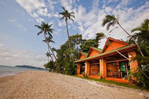 a house on the beach next to the ocean at Friendship Beach Resort & Atmanjai Wellness Centre in Rawai Beach