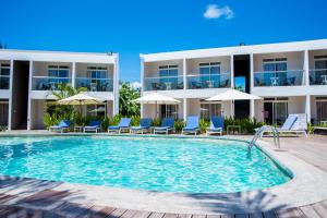 a swimming pool in front of a hotel at Villas Mon Plaisir in Pointe aux Piments